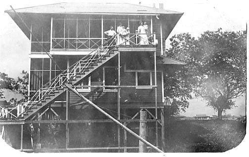 A view of a raised house for an American management worker and his family during construction of the Panama Canal.  Approximately 1911.
